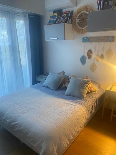 a bed with white sheets and pillows in a room at Vannina in Bastia