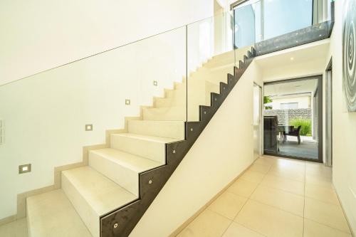 a staircase in a house with white walls at Villa Shangrila in Naturno
