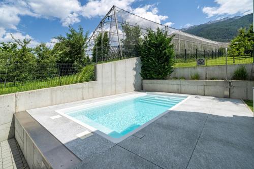 a swimming pool in the middle of a patio at Villa Shangrila in Naturno