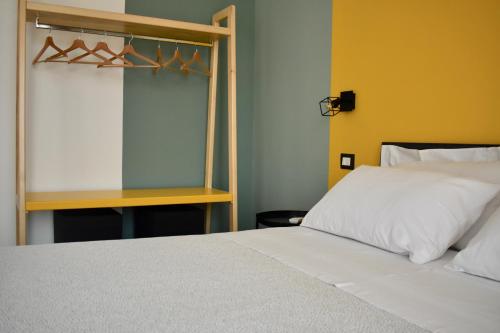 a bedroom with a white bed and a window at Domus Solis in Pachino