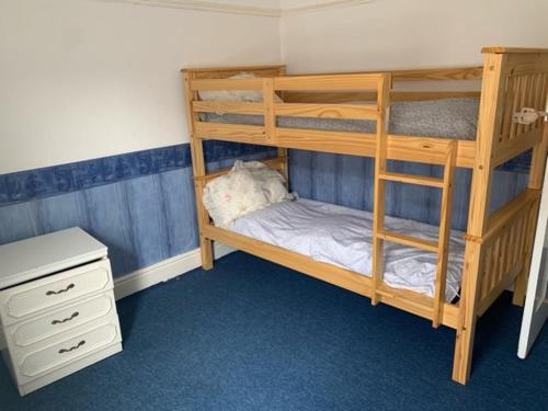 a bunk bed room with two bunk beds and a desk at Anfield view in Liverpool