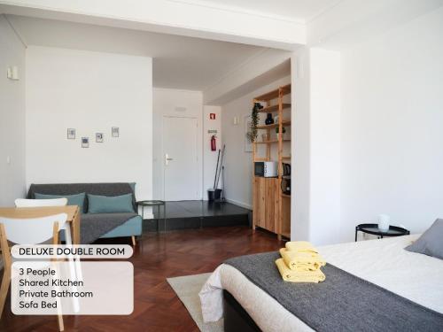 a bedroom with a bed and a living room at Studio 59 Lisboa in Lisbon
