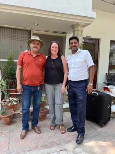 a group of three people standing in front of a house at Alibaba’s Indiana Homestay in Agra