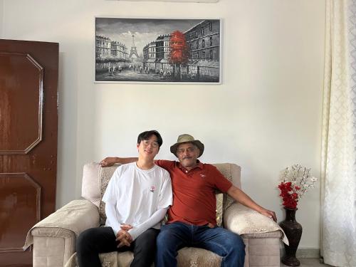 a man and a woman sitting in a chair at Alibaba’s Indiana Homestay in Agra