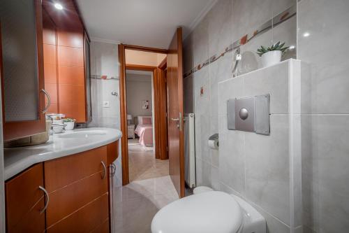 a bathroom with a toilet and a sink at Leas House in Preveza