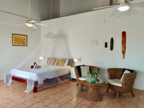 a bedroom with a bed and a table and chairs at Villa San Sebastian Curaçao in Fontein