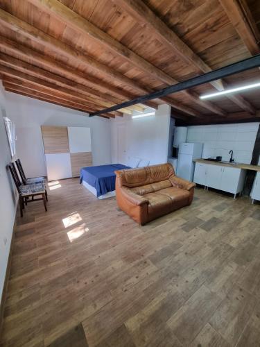 a living room with a couch and a bed at Alojamiento con finca en Gijón 
