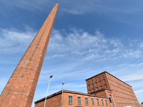 a tall brick building with a tall tower in front of it at The Engine House in Carlisle