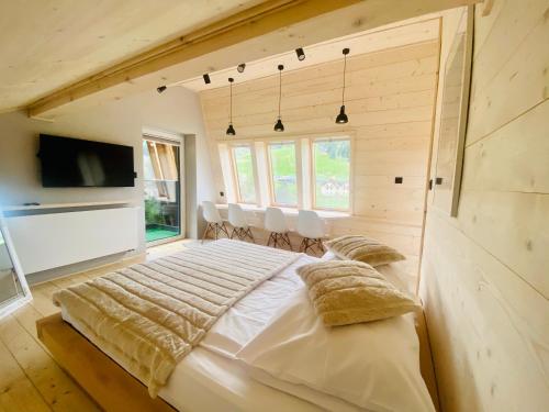 a bedroom with a large bed with pillows on it at Apartament Widoknastok in Korbielów