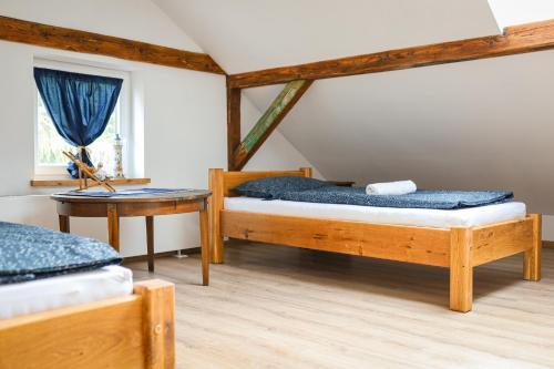 a bedroom with two twin beds and a table at Domy pod 12-stką in Mrągowo