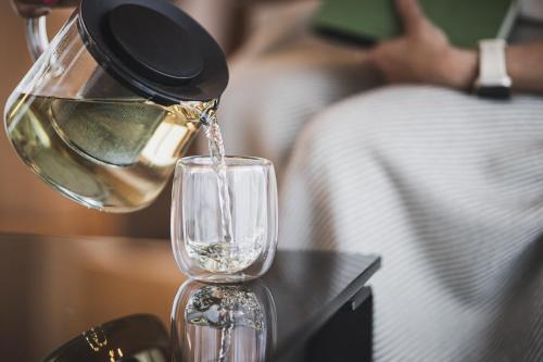 a person pouring wine into a wine glass at Residence Nives in Bressanone