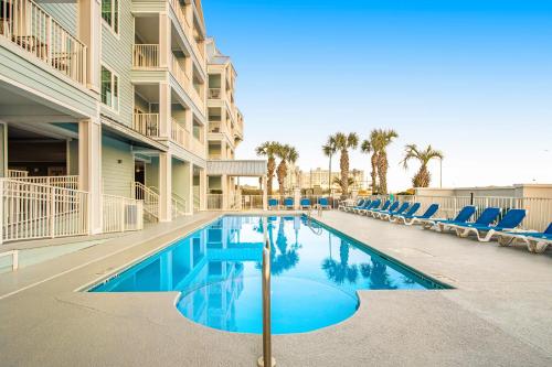 a swimming pool in the middle of a apartment building at Grand Caribbean #425 in Orange Beach