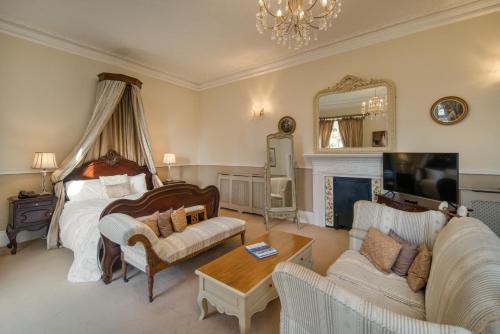 a bedroom with a bed and a living room at Albert Cottage Hotel in East Cowes