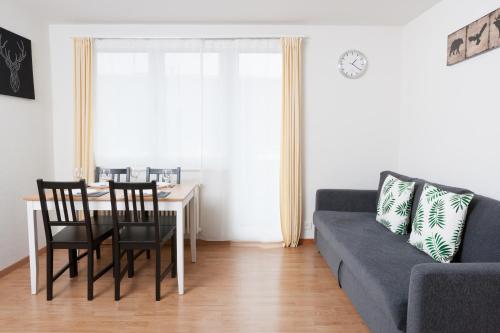 a living room with a table and a couch at Galaxy Apartments Lucerne in Luzern