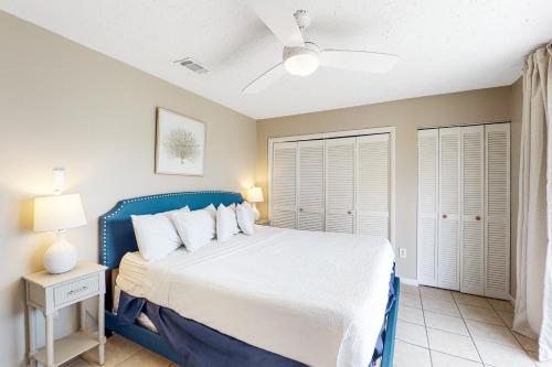 a bedroom with a blue bed with white pillows at Southwind C-2 in Panama City Beach