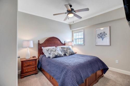 a bedroom with a bed and a ceiling fan at FFR101 - The Wright Idea in Kill Devil Hills