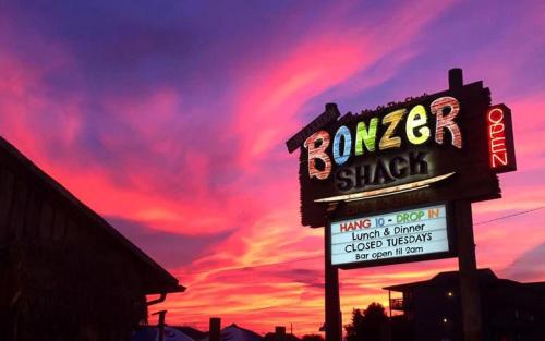 a sign for a burger shack with a sunset at FFR114 - Nemo's Retreat in Kill Devil Hills