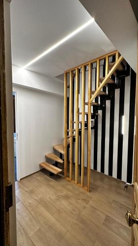 an empty room with a staircase in a house at Katrine in Saint-Étienne