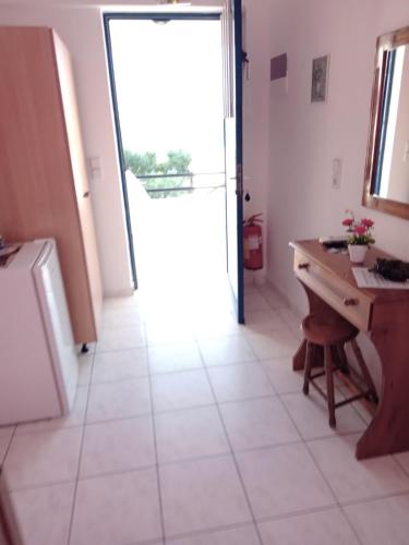 a kitchen with a desk and a door open at The Captain in Elafonisos