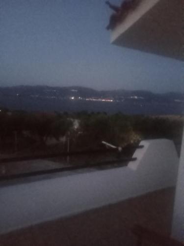 a view of a city at night from a window at The Captain in Elafonisos