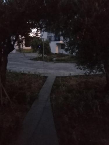 a walkway leading to a street with a house at The Captain in Elafonisos