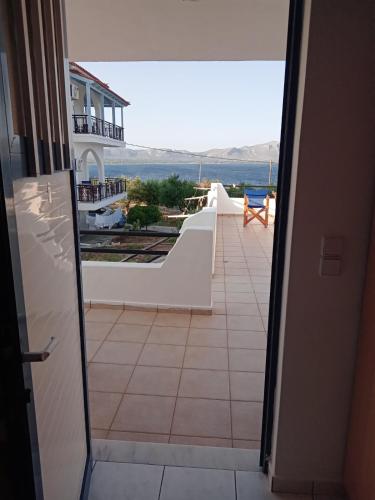 a view from a door of a balcony with the ocean at The Captain in Elafonisos