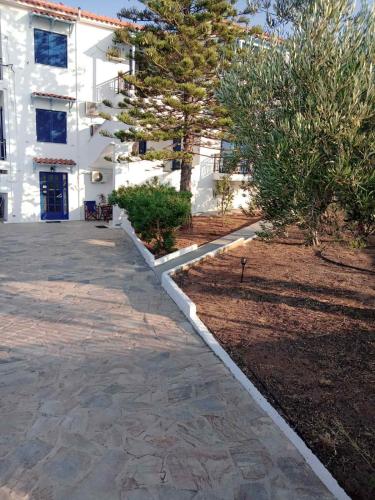 a walkway in front of a white building at The Captain in Elafonisos