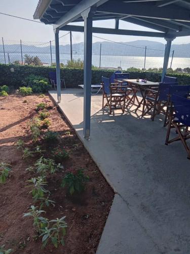 a patio with a table and chairs under a canopy at The Captain in Elafonisos