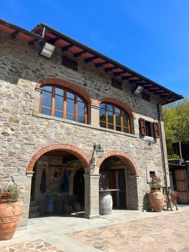 a large stone building with a large arch doorway at Agriturismo La Selva di Frena in Firenzuola