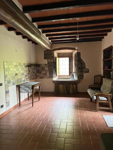 a large room with a table and a window at Agriturismo La Selva di Frena in Firenzuola