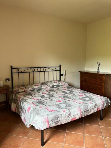 a bedroom with a bed and a wooden dresser at Agriturismo La Selva di Frena in Firenzuola