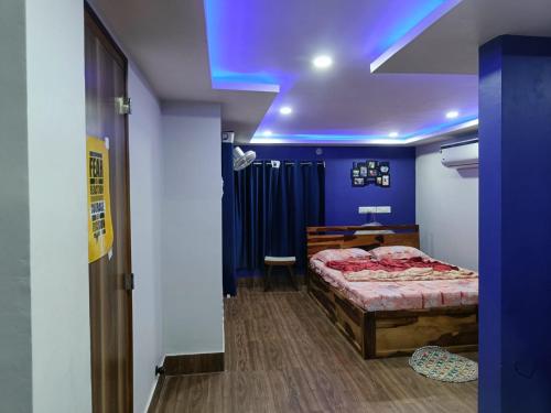 a bedroom with a bed and a blue ceiling at Terrace garden & Unique 1 bedroom AC rental unit in Haldia in Haldia