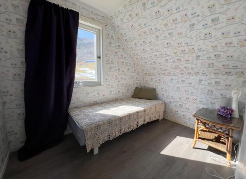 Kleines Zimmer mit einem Bett und einem Fenster in der Unterkunft Overnating i Sauda in Sauda