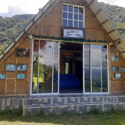 a house with large glass doors on the porch at Glamping eco descanso la vega Nocaima in Nocaima