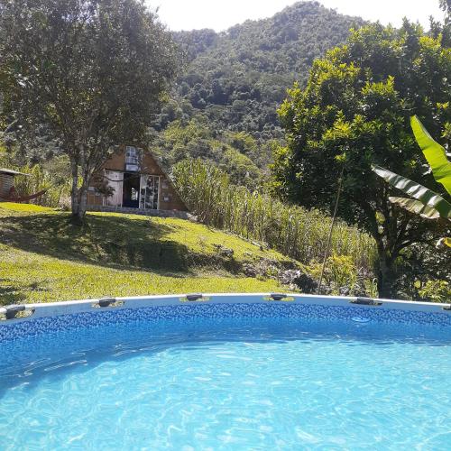 a swimming pool with a view of a mountain at Glamping eco descanso la vega Nocaima in Nocaima