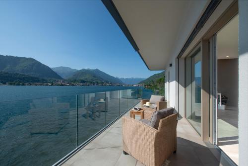 a balcony with a view of the water and mountains at d'Ocalée Holiday Experience lago d'Orta in Omegna