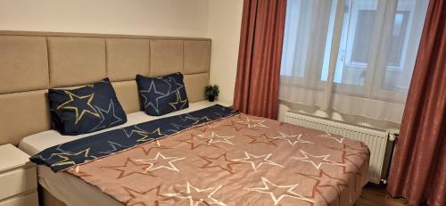 a bedroom with a bed with stars on it at Apartman Živković in Leskovac