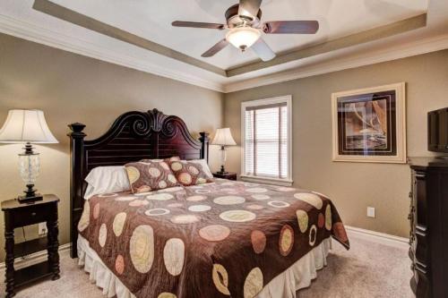 a bedroom with a bed and a ceiling fan at CSC4I - The Platinum Suite in Kill Devil Hills