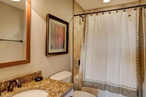 a bathroom with a sink and a toilet and a shower at CSC4I - The Platinum Suite in Kill Devil Hills