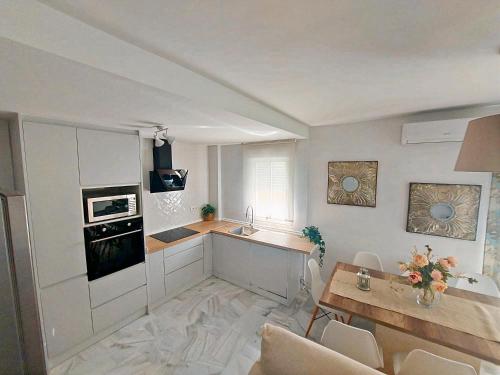 een woonkamer met een keuken en een tafel bij Barrameda 19 in Sanlúcar de Barrameda