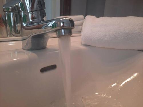 a bathroom sink with water coming out of a faucet at GROSSI 19 Rho fiera in Rho