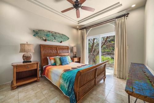a bedroom with a bed and a ceiling fan at Matapalo 201 in Tamarindo
