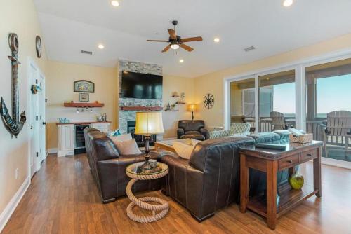 a living room with a couch and a table at RSR3C - Sunsets Galore in Rodanthe