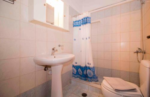 a bathroom with a sink and a toilet at Laconian Collection # Gytheio Sea View Georgia Apartment# in Gythio