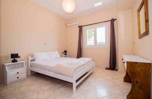 a bedroom with a white bed and a window at Laconian Collection # Gytheio Sea View Georgia Apartment# in Gythio