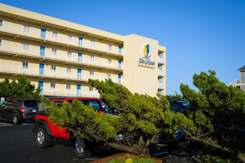 a red truck parked in front of a hotel at SR-T2 - Sea Ranch Resort - Prime Oceanfront condo Oceanviews Indoor Pool Restaurant in Kill Devil Hills