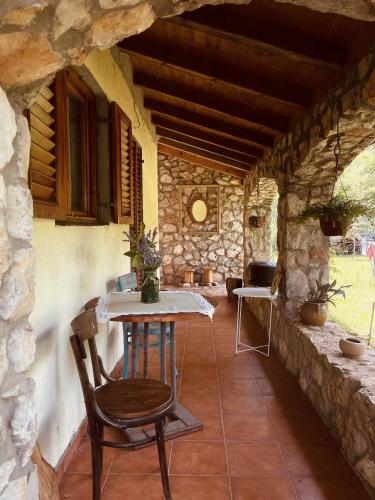 a table and a chair in a stone house at Village house Velimirović in Danilovgrad