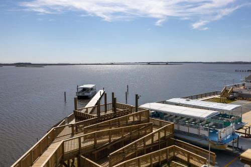 a dock with a boat in the water at Sunrises to Sunsets in Nags Head