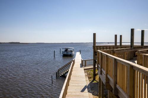 a boat on the water next to a dock at Sunrises to Sunsets in Nags Head