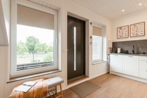 a kitchen with a large window in a room at Lapmanni Studios in Haapsalu